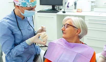 A dentist and patient chatting about dental implants