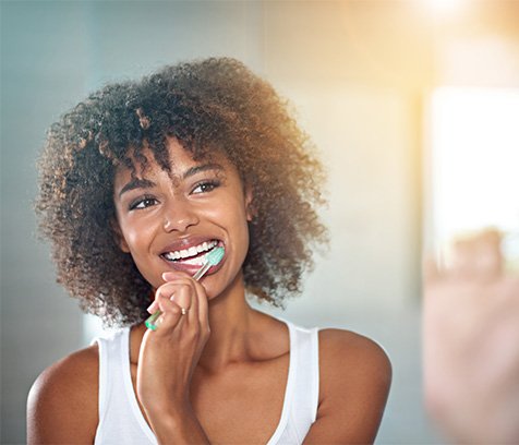 A woman brushing her teeth
