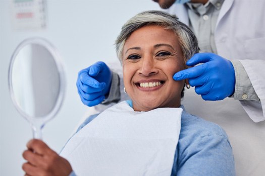 Older woman smiling after cosmetic dentistry