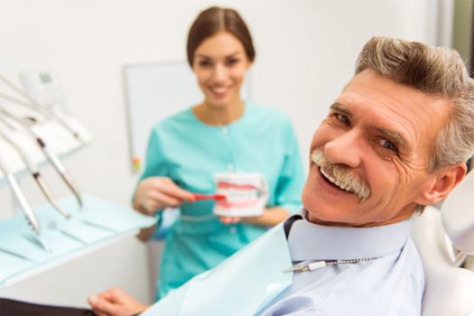 Man smiling after getting dentures