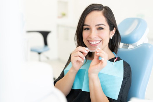 Woman smiling with her Invisalign clear aligners