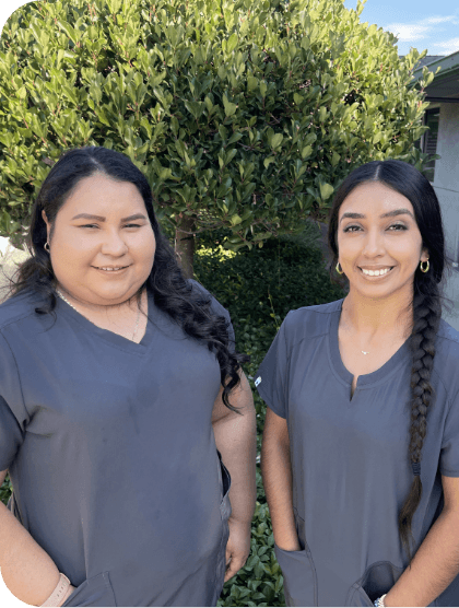 two members of dental team smiling together