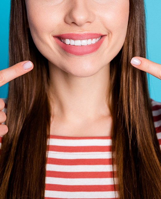 a patient pointing to veneers