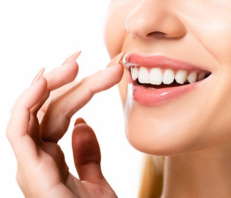 a close-up of a patient with veneers smiling 