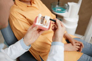 an older patient speaking with their dentist about dental implants