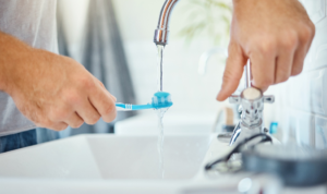 a person brushing their teeth at home