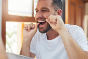 a person flossing their teeth