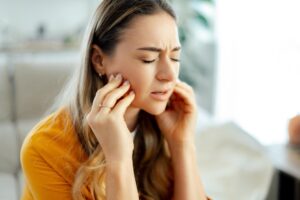 a woman dealing with tooth sensitivity