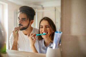 a couple brushing their teeth together