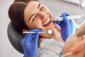 a patient smiling while visiting their dentist