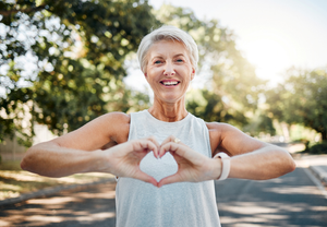 a person holding a heart over their chest